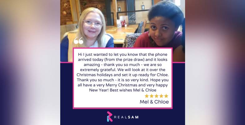 Image shows a picture of Chloe sitting with her mum Mel. They are both smiling at the camera. Chloe and Mel have sent a thank you message on hearing the news they have won a RealSAM Phone