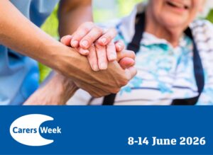 A Carers Week graphic showing a close-up of two pairs of hands — one younger, one older — clasped together warmly. The older person is seated in a wheelchair. It is a depiction of caring for someone with sight loss. Below, a royal blue banner displays the official Carers Week logo alongside the text "8–14 June 2026" in white.